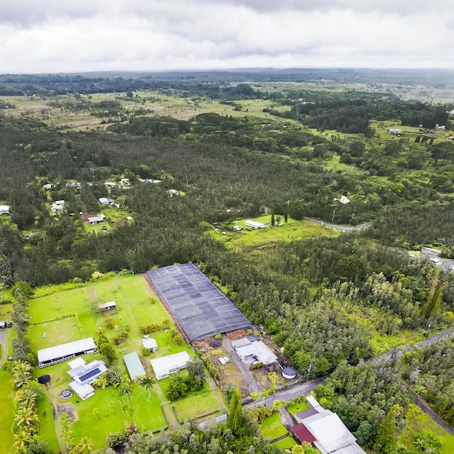 drone / aerial view featuring a wooded view