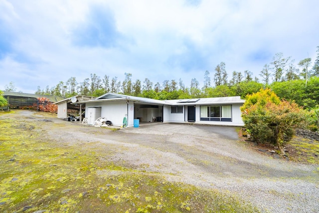 single story home featuring an attached carport and driveway