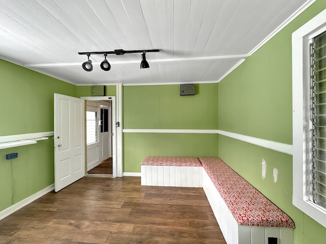 interior space featuring ornamental molding, track lighting, and hardwood / wood-style floors