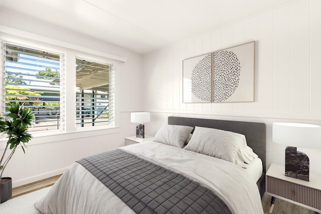 bedroom featuring multiple windows and hardwood / wood-style floors