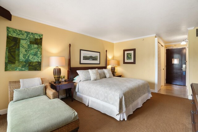 bedroom with crown molding, tile patterned flooring, and a closet