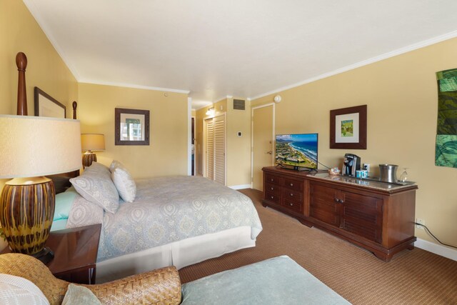 bedroom featuring crown molding, carpet, and a closet