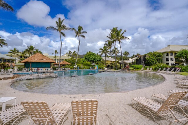 view of swimming pool featuring pool water feature and a patio area