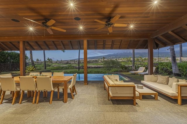 view of patio with a ceiling fan, a pool, outdoor dining area, and outdoor lounge area