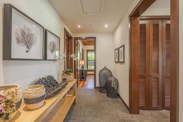 corridor featuring baseboards and recessed lighting