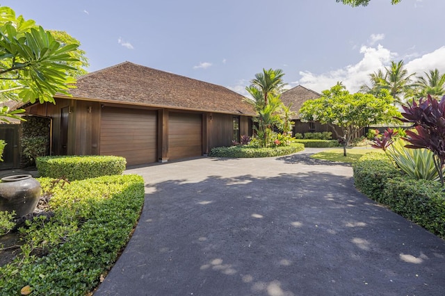 view of side of property with an attached garage and concrete driveway