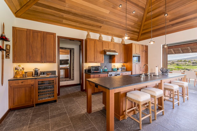 kitchen with pendant lighting, wood ceiling, sink, and high vaulted ceiling