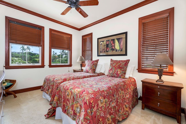 carpeted bedroom featuring ceiling fan and ornamental molding