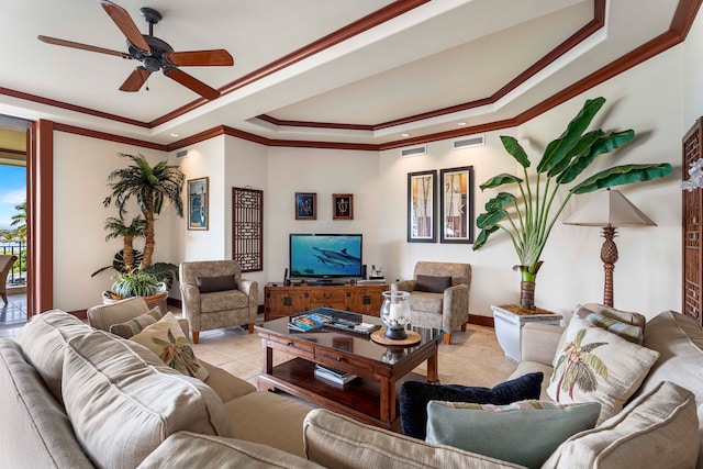 tiled living room with a raised ceiling, crown molding, and ceiling fan