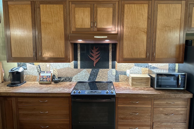 kitchen with black range with electric stovetop, tasteful backsplash, and custom exhaust hood