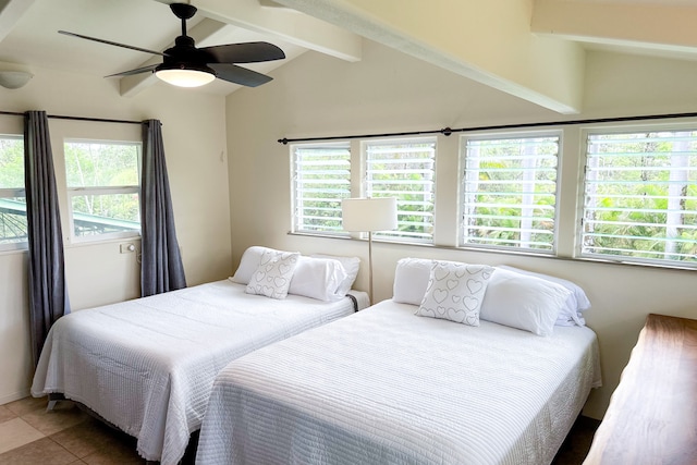 bedroom with multiple windows, ceiling fan, vaulted ceiling with beams, and tile patterned flooring