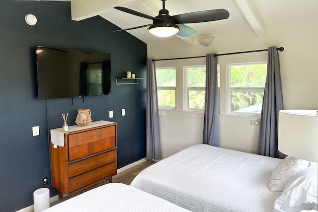 tiled bedroom with lofted ceiling with beams and ceiling fan