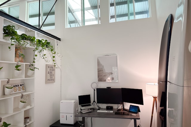 office area featuring a towering ceiling