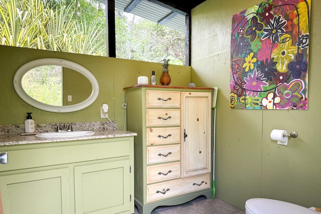 bathroom featuring tile patterned floors, vanity, and toilet