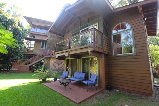 rear view of property with a yard and a patio