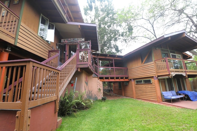 rear view of property featuring a yard