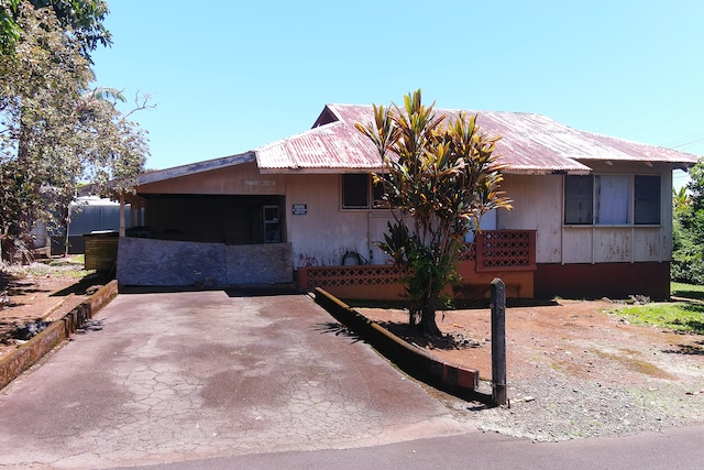 ranch-style house featuring a garage and a carport