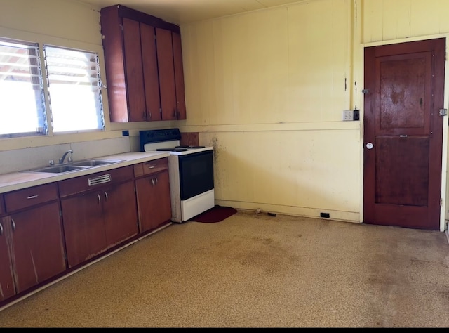 kitchen featuring sink and white range with electric stovetop