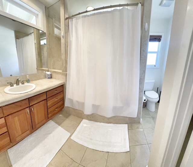 bathroom featuring tile patterned floors, toilet, and vanity