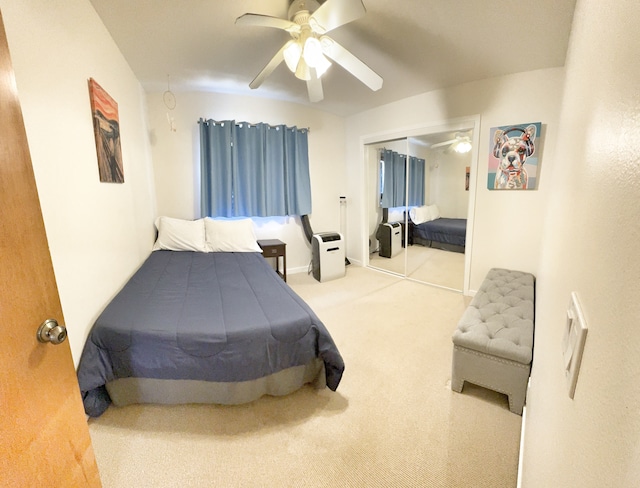 carpeted bedroom featuring a closet and ceiling fan