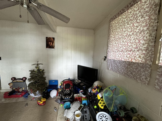 unfurnished bedroom featuring ceiling fan and beam ceiling