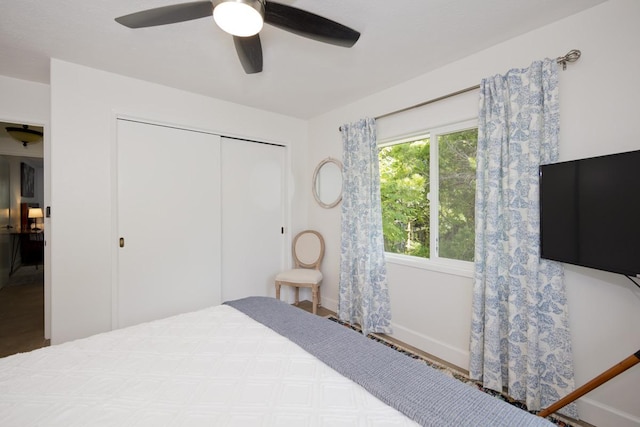 bedroom with ceiling fan and a closet