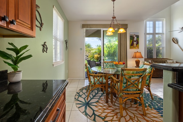 dining area featuring a chandelier and light tile patterned floors