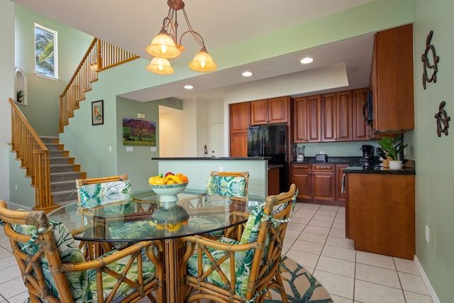 dining room featuring light tile patterned flooring, an inviting chandelier, and sink