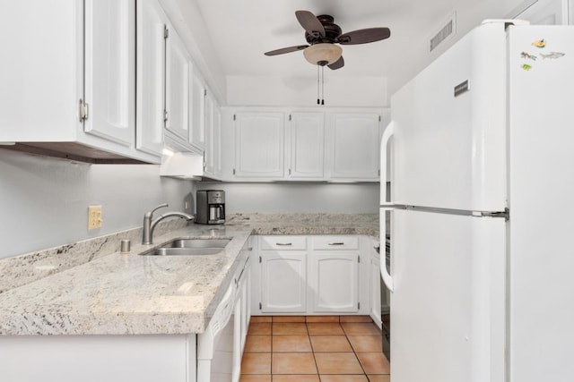 kitchen with sink, white appliances, light tile patterned floors, ceiling fan, and white cabinets