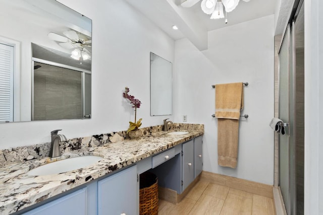 bathroom with tile patterned flooring, vanity, an enclosed shower, and ceiling fan