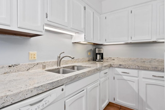 kitchen with white cabinetry, sink, light tile patterned floors, and white dishwasher