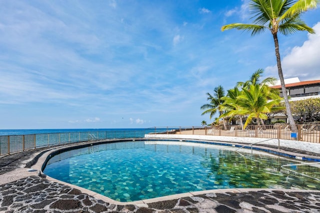 view of swimming pool featuring a water view