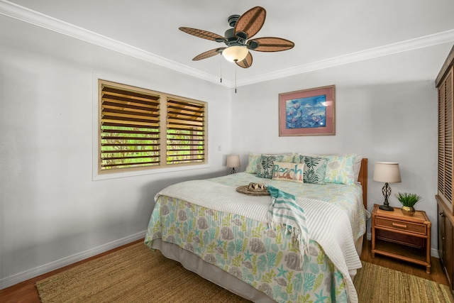 bedroom with crown molding, dark wood-type flooring, and ceiling fan