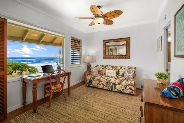 living room featuring a water view, hardwood / wood-style floors, ornamental molding, ceiling fan, and beam ceiling