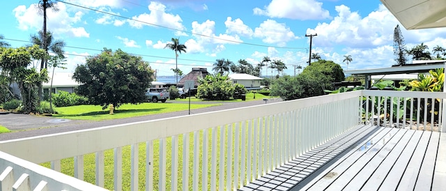 wooden terrace with a lawn