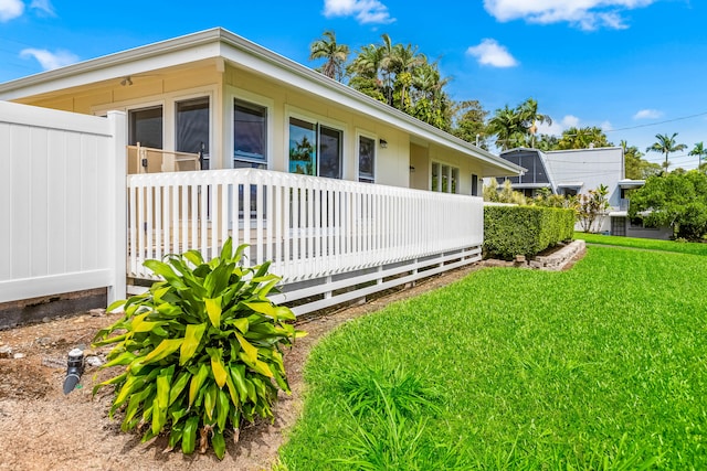 view of side of home featuring a lawn