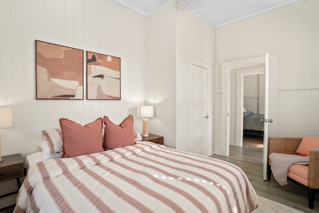 bedroom with wood-type flooring and ornamental molding