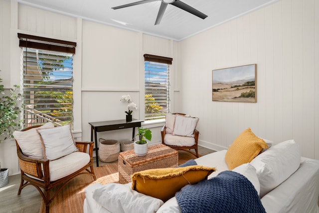 interior space with crown molding, hardwood / wood-style floors, and ceiling fan