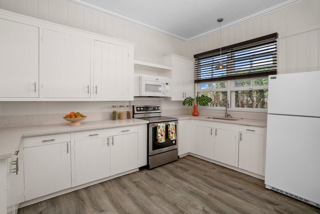 kitchen featuring wood-type flooring, white cabinets, white appliances, ornamental molding, and sink