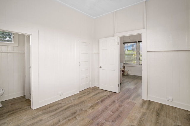 unfurnished bedroom with hardwood / wood-style flooring