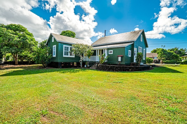 back of property featuring a lawn