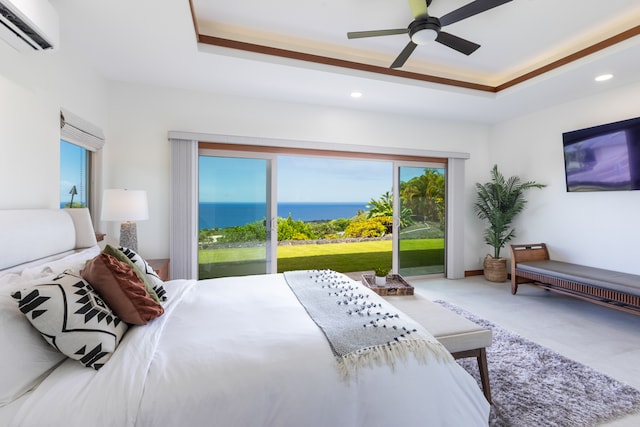 bedroom with a wall mounted AC, ceiling fan, a raised ceiling, and access to exterior