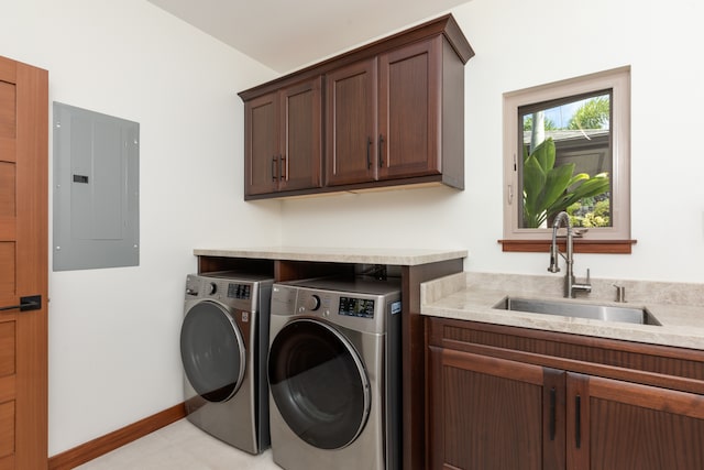 clothes washing area featuring electric panel, cabinets, sink, and independent washer and dryer