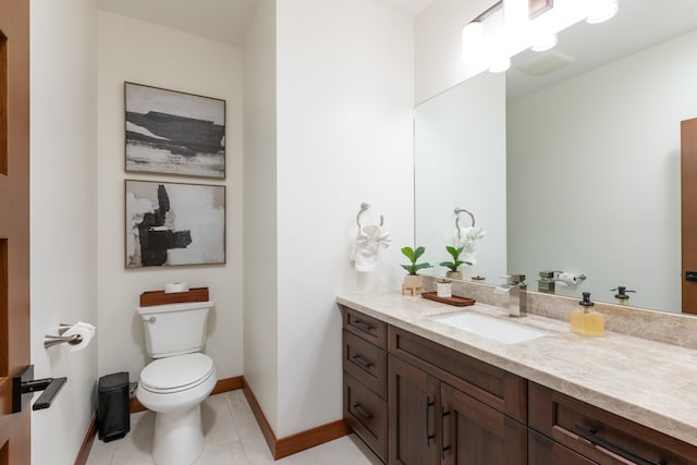 bathroom featuring tile patterned flooring, vanity, and toilet