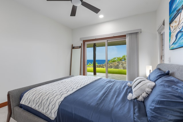 bedroom featuring a water view, ceiling fan, and access to exterior