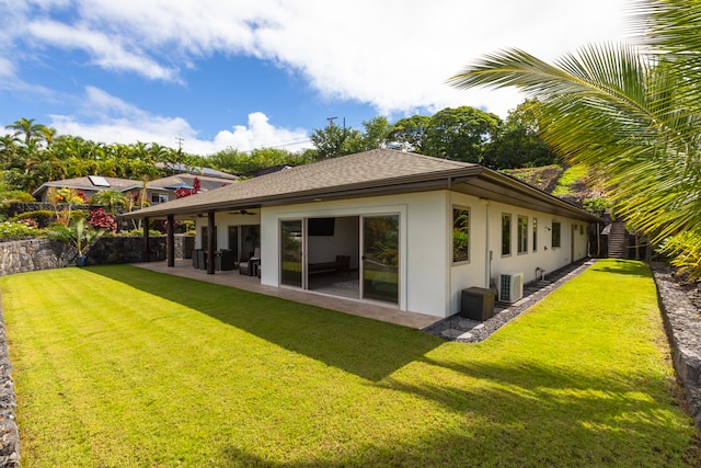 rear view of property featuring central AC, a lawn, and a patio area