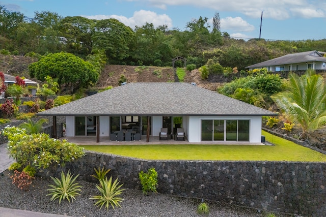 single story home featuring a front yard and a patio