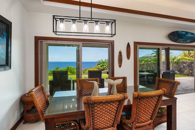 tiled dining space with a water view and plenty of natural light