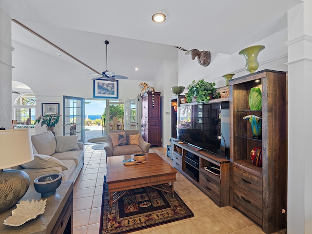 living room with light tile patterned floors, a wealth of natural light, ceiling fan, and high vaulted ceiling