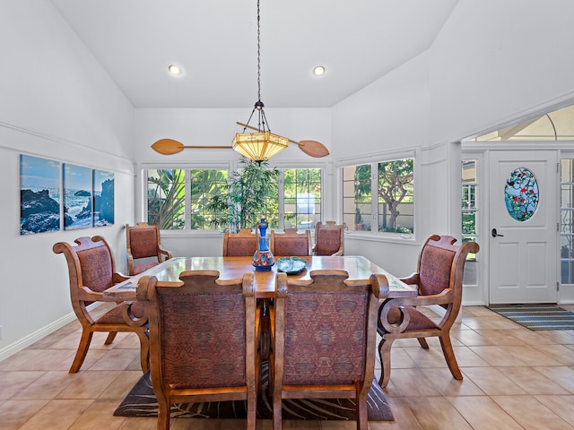 dining room featuring light tile patterned flooring and high vaulted ceiling